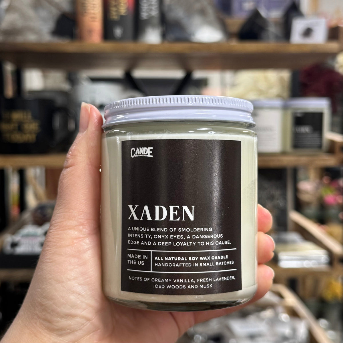 Dark labeled candle with Xaden label.