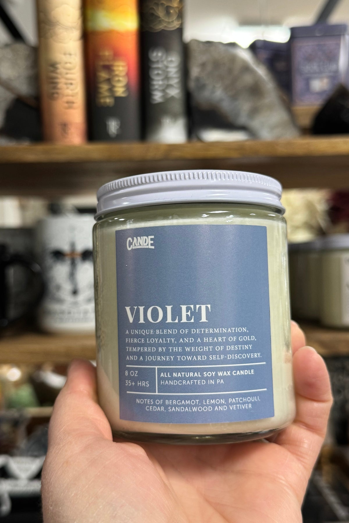 Clear Glass Candle with White lid, square label with name Violet for fourth wing character.