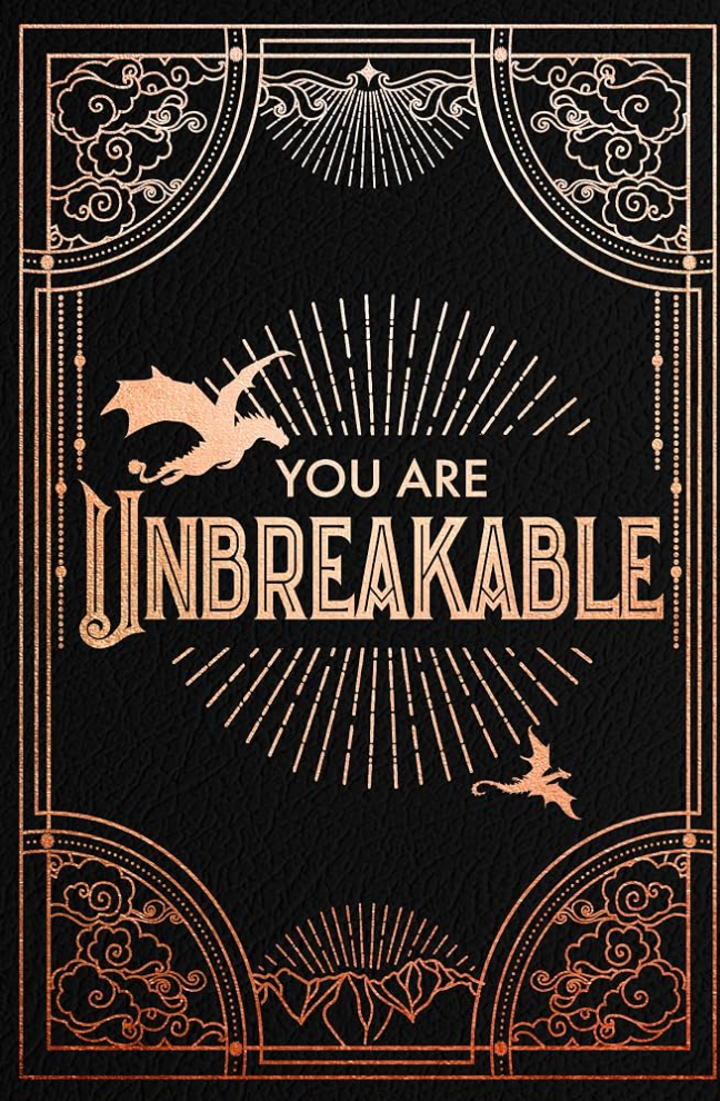 A square black textured print or poster with ornate rose-gold Art Deco-style border details and the centered text 'YOU ARE UNBREAKABLE,' accompanied by two small dragon silhouettes.