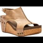 Gold wedge sandal with cork sole on a white background