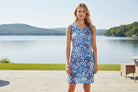 woman in with and blue dress on a lakeside patio